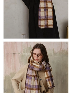 Detail view of purple and brown plaid knit scarf with cozy wool-like texture and fringed edges