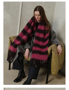 Detailed view of the thick purple and brown striped plaid scarf with fringe tassels