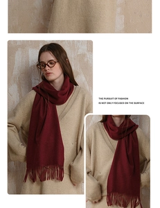 Detailed view of wine red wool scarf featuring fine tassel texture and soft autumn style