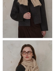 Close-up of diamond lattice knit scarf with retro tortoiseshell glasses and grey coat