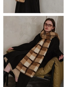 Close-up of vintage brown plaid wool scarf with thick knitted texture and fringe detail