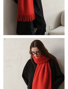 Detail of red wool blend scarf showing thick knit texture and long tassel fringes