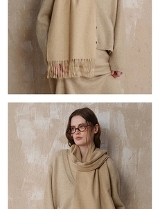 Close-up of beige wool scarf featuring soft knit texture and long fringe tassels
