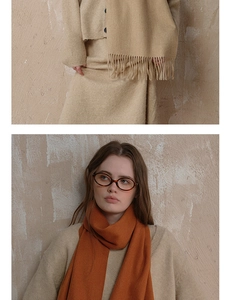 Detailed close-up of soft fringe and premium wool texture of oatmeal beige winter scarf