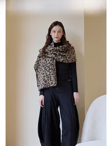 Close-up of thick leopard print scarf draped over a black outfit for a vintage look