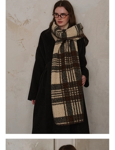 Close-up of thick plaid scarf with brushed texture and whipstitched edges