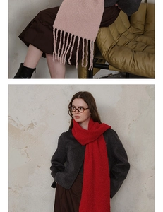 Close-up of thick wool knit texture and long tassel details on a soft winter scarf