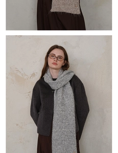 Detailed texture of grey knit scarf with soft wool fibers and elegant diamond pattern