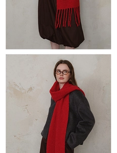 Detail of red knitted wool scarf with fringe showing thick soft texture for winter warmth