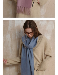 Detail of wool scarf tassels and soft knit texture in gray-blue and dusty pink tones