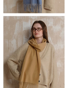 Close-up of camel and blue wool scarves with fringe detail for autumn winter style
