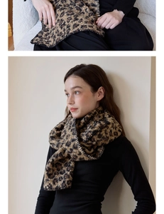 Close-up of leopard print wool scarf featuring black whipstitch edges and thick texture
