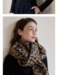 Detail of leopard print wool scarf featuring premium blanket stitch edges and soft texture