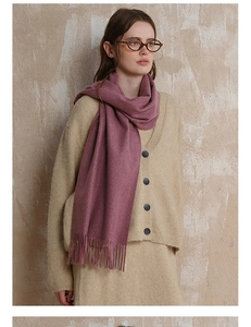 Detailed view of mauve wool scarf featuring classic fringe edges and warm knitted texture
