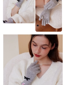 Detail showing wool blend knitted gloves with elegant black bow and soft texture