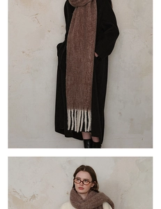 Close-up of thick wool scarf with decorative fringe tassels and minimalist design