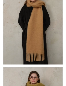 Close-up of thick wool blend scarves with fringes in camel and olive green colors