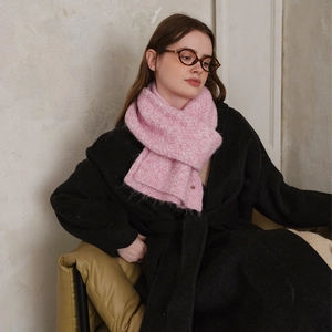 Women's pink diamond-pattern knitted scarf in soft winter knit styled with a black coat