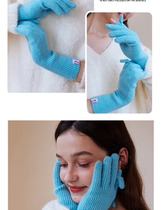 Close-up of blue wool knit gloves showing ribbed texture and pink brand woven label
