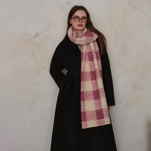 Pink and beige plaid oversized wool scarf for women paired with a long black winter coat