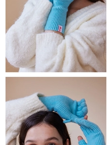 Detail of light blue wool knit fingerless gloves with ribbed texture and flip cover