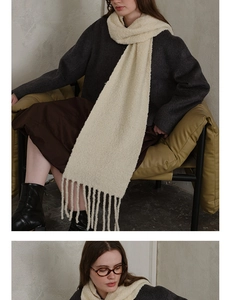 Close-up of cream wool blend knit scarf showing textured bouclé fabric and tassels