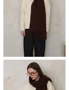 Detail of dark brown wool blend scarf with thick fringe tassels and fuzzy texture