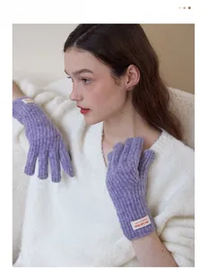 Detail showing the purple knit texture and woven label on a winter warm glove