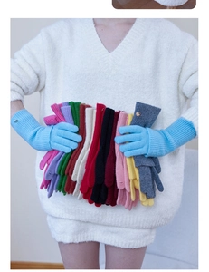 Detail of wool knit gloves in various colors with ribbed cuffs and metal button accents