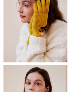 Detailed view of ginger wool blend knit gloves featuring elegant black ribbon bows and buttons