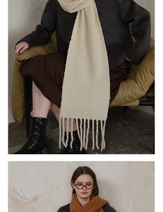 Close-up of wool-blend knit scarf with bouclé texture and long fringe tassels