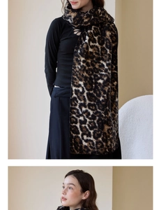 Detailed texture of thick leopard print wool-like scarf with soft fringe and warm knit