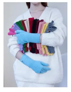 Close-up of colorful wool blend knit gloves featuring a stylish metallic logo emblem