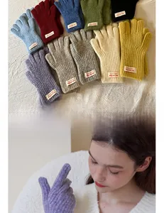 Detail view of colorful touchscreen winter gloves with knit texture and branded tags