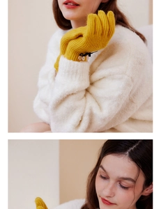 Detail of yellow wool gloves with black bow and buttons on ribbed knit wrist