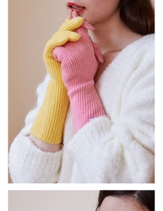 Detail of ribbed knit wool gloves in pink and yellow for autumn winter warmth