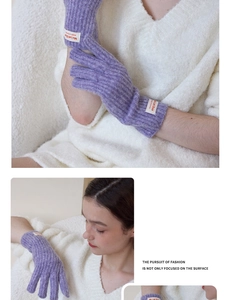 Close-up of purple ribbed knit gloves with touch-screen capability and woven brand label