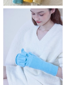 Close-up of light blue ribbed knit wool gloves with extended cuff for winter warmth