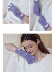 Close-up of purple ribbed knit gloves with touch screen fingers and brand woven label