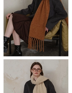 Detailed texture of thick wool-blend scarf with tassels in brown and ivory white