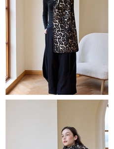 Fashionable leopard print wool-like scarf styled with a sleek black knit top and trousers