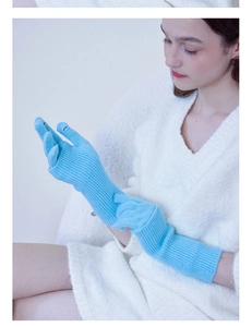 Detail of light blue knitted wool gloves with a practical convertible fingerless design