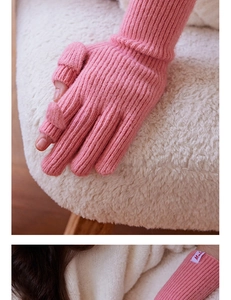 Detailed close-up of pink wool-blend knitted gloves with functional thumb flap design