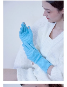 Detail of light blue knitted wool glove featuring a convertible fingerless design for winter