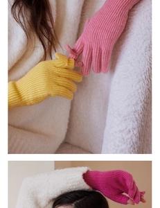 Close-up of wool knit fingerless gloves showing rib texture and warm pastel colors