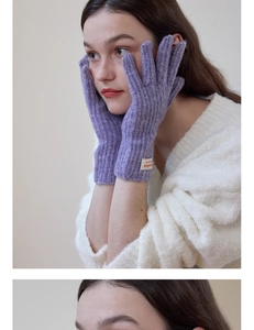 Close-up of purple ribbed knit gloves with a branded woven label for winter warmth