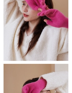 Detail of rose pink wool knit gloves featuring a fingerless design and ribbed texture