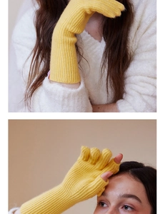 Close-up of ginger yellow wool knit fingerless gloves with elegant ribbed texture