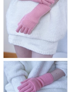 Close-up of pink knit gloves with vertical ribbed texture paired with white faux fur