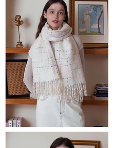 Detail of cream plaid cashmere-like scarf featuring soft fringe and subtle pastel patterns